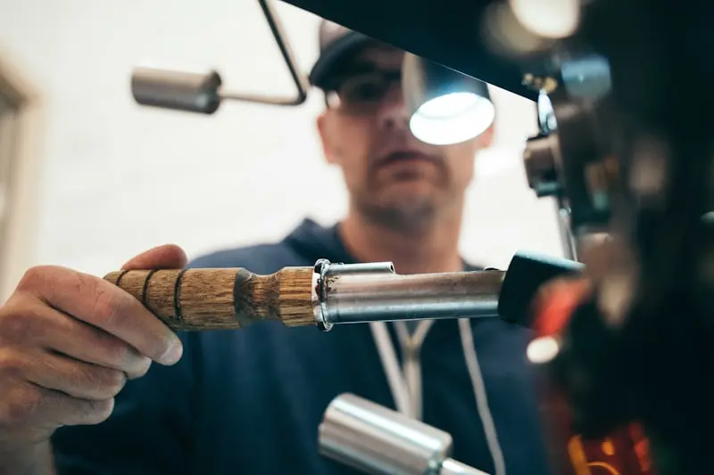 Plumber fixing a pipe under a sink