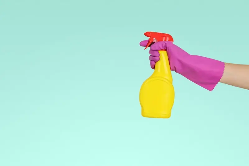 Cleaning supplies laid out on a wooden floor