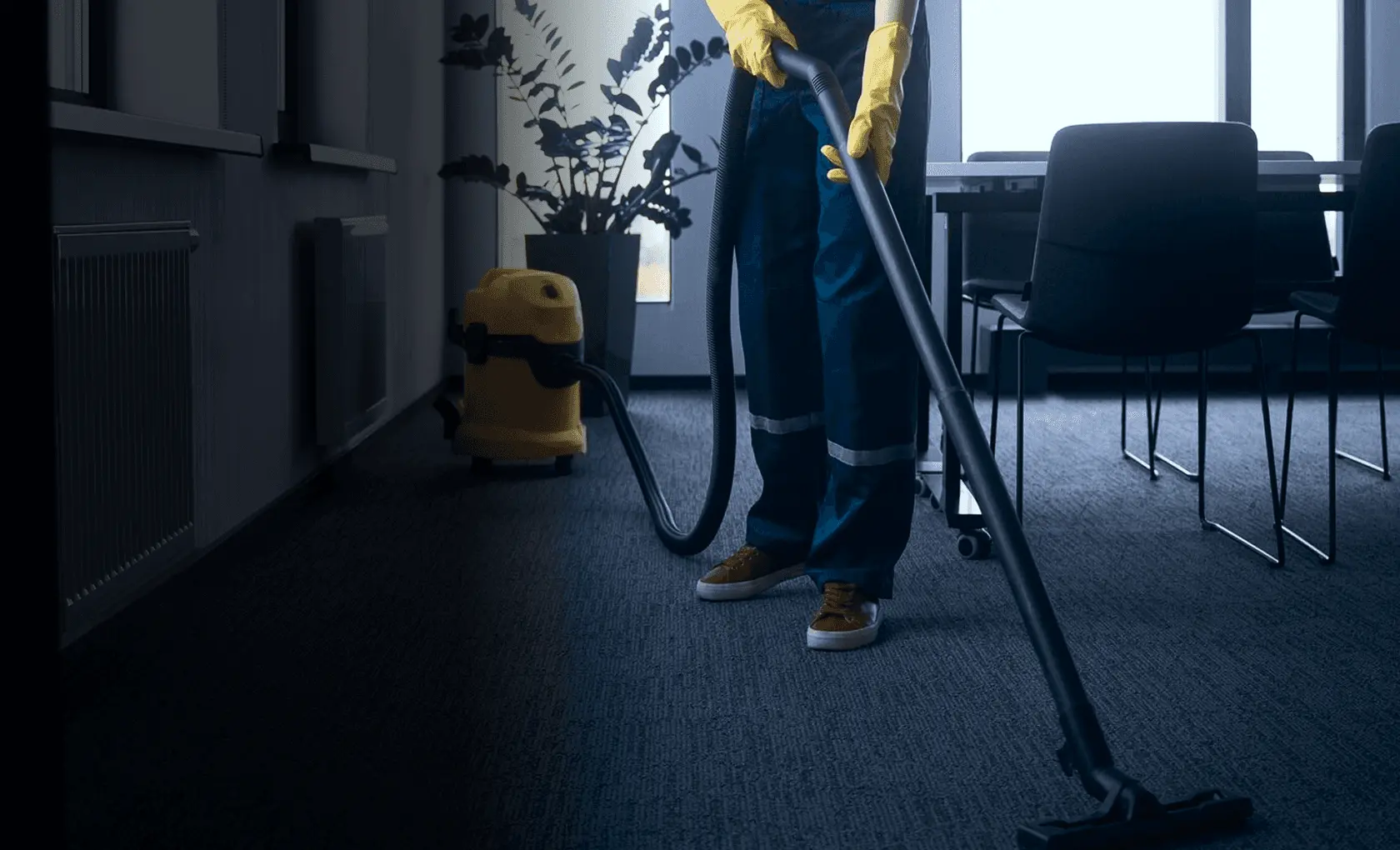 Cleaning professional vacuuming an office