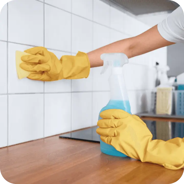 Professional cleaning a wall and surfaces